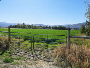 View of mountain backdrop featuring rural landscape
