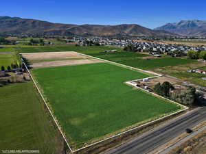 Aerial view of sparsely populated area with property boundaries highlighted, mountains, and farmland