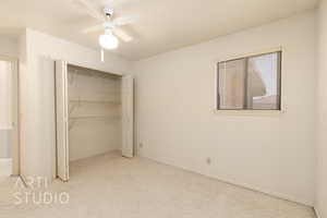 Unfurnished bedroom with carpet, ceiling fan, and a closet
