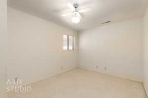 Carpeted spare room with ceiling fan and a textured ceiling