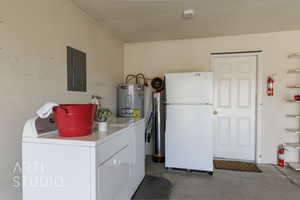 Washroom with electric panel, electric water heater, and washer and dryer
