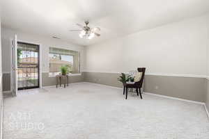 Sitting room with light carpet and ceiling fan