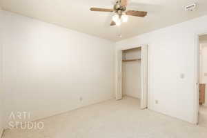 Unfurnished bedroom with carpet floors, ceiling fan, and a closet