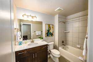 Bedroom 2 ensuite full bath with shower / bath combination, vanity, and laminate floors