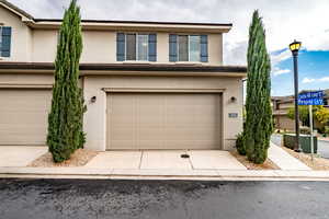 Traditional-style house featuring stucco siding, concrete driveway, and an attached garage