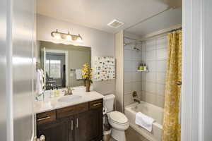 Bedroom 3 ensuite full bath with shower / bath combo, vanity, and laminate floors