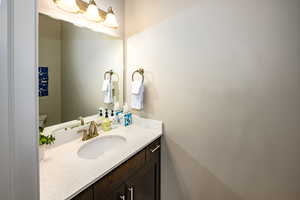 Half bathroom featuring vanity and toilet