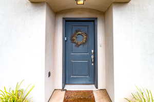 View of exterior entry featuring stucco siding