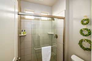 Primary ensuite bathroom featuring a shower stall