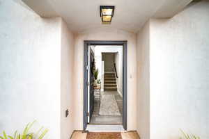 Property entrance featuring stucco siding