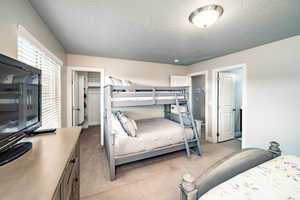 Bedroom 3 featuring light carpet and a spacious closet