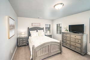 Bedroom 3 featuring light colored carpet and baseboards