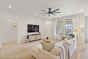 Living area featuring recessed lighting, light carpet, and ceiling fan