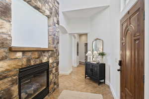 Hallway featuring light tile patterned floors and arched walkways
