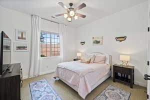 Bedroom with light colored carpet and ceiling fan