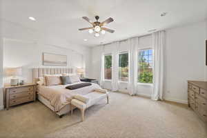 Bedroom with light carpet, ceiling fan, and recessed lighting