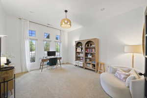 Office space with light carpet and baseboards