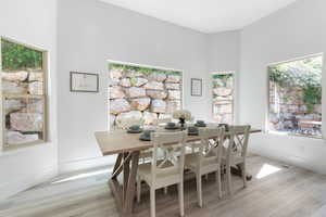Dining area with light wood finished floors and baseboards