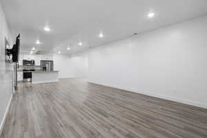 Unfurnished living room with light wood-style flooring and recessed lighting