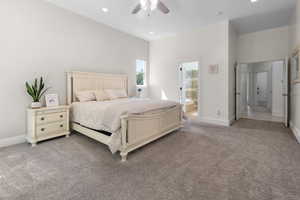 Carpeted bedroom with recessed lighting, a ceiling fan, and ensuite bath