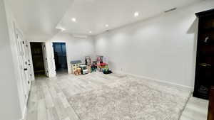 Playroom featuring light wood finished floors and recessed lighting