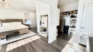Bedroom with wood finished floors and recessed lighting