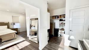 Bedroom with dark wood finished floors and recessed lighting