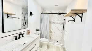Full bathroom featuring vanity and a stall shower