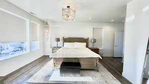 Bedroom with wood finished floors and recessed lighting