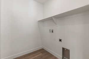 Washroom featuring dark wood-style flooring, hookup for a washing machine, and electric dryer hookup
