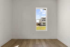 Empty room featuring light wood-style flooring and baseboards
