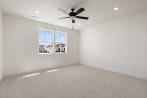 Spare room featuring light colored carpet, recessed lighting, and ceiling fan
