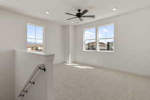 Carpeted empty room featuring healthy amount of natural light, recessed lighting, and ceiling fan