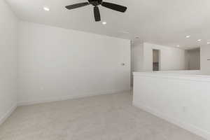 Empty room featuring light carpet, recessed lighting, and a ceiling fan