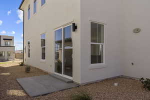 Back of property with a patio area and stucco siding