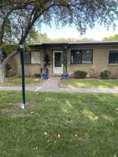 Ranch-style home with a front lawn and brick siding