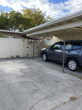 View of parking / parking lot featuring a gate