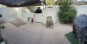 Fenced backyard with area for grilling