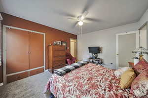 Bedroom with carpet flooring, a closet, and ceiling fan