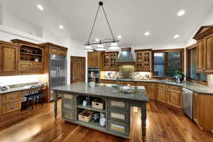 Kitchen with open shelves, a kitchen breakfast bar, pendant lighting, backsplash, and recessed lighting