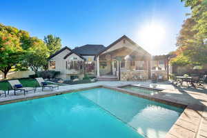 View of pool with a patio, an in-ground hot tub, and outdoor dining space