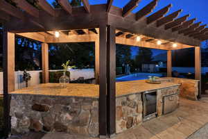 Pergola with granite countertops, drink fridge