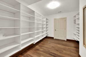 Storage closet featuring built in shelves
