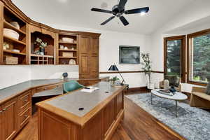 Office featuring hardwood desk and built in bookcases
