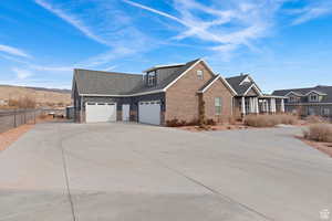 Craftsman inspired home with concrete driveway, covered porch, board and batten siding, and a shingled roof