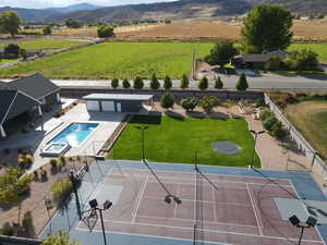 Aerial view of sparsely populated area with mountains and a pool
