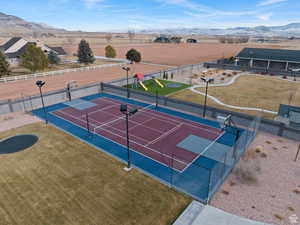 View of tennis court featuring a mountain view and community basketball court