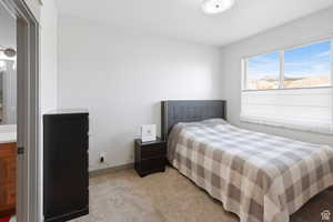 Carpeted bedroom featuring baseboards