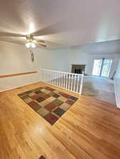 Dining room with a textured ceiling, light wood finished floors, and ceiling fan