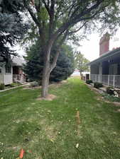 View of green lawn with a porch